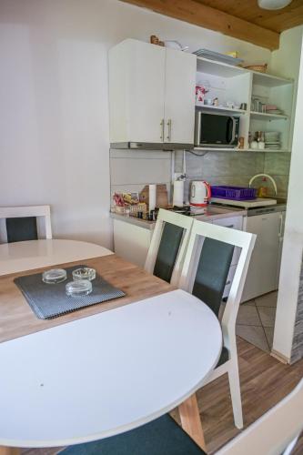 a kitchen with a table and chairs in a room at Forest Dream Lake House in Jajce