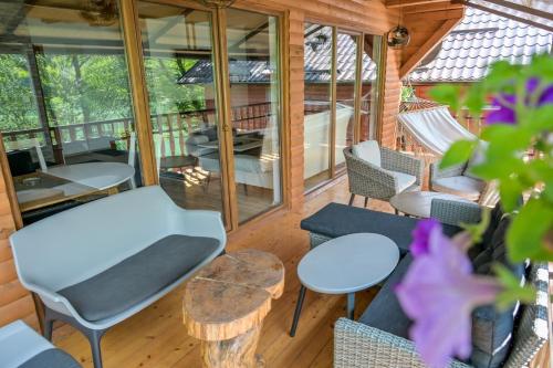 a screened in porch with a table and chairs at Forest Dream Lake House in Jajce