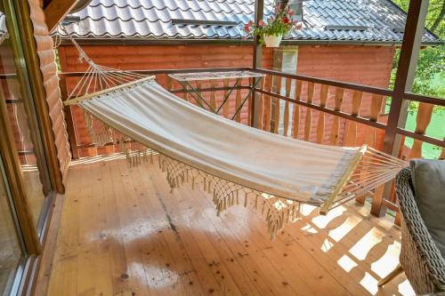 a hammock on a screened in porch at Forest Dream Lake House in Jajce