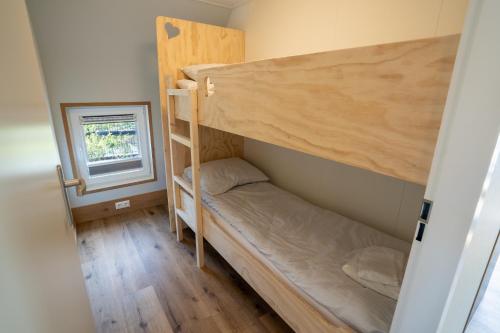 a bedroom with two bunk beds and a window at 't Landgoed Baars in Baars