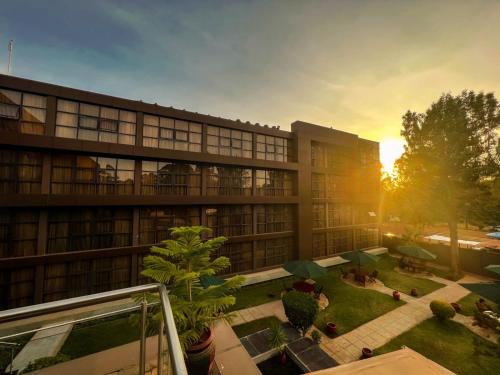 an office building with a sunset in the background at Boma Inn Eldoret in Eldoret