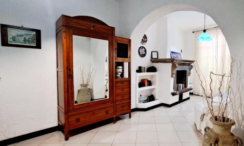 a room with a large wooden cabinet with a mirror at Hotel Poseidon in Lipari