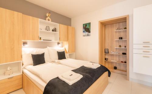 Posteľ alebo postele v izbe v ubytovaní Jégmadár & Fekete Gólya Apartmanok