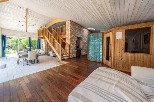 a bedroom with a staircase and a dining room at Le domaine du coudret in Saintes