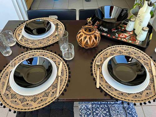 a table with plates and glasses on top of it at AM Apartment on the beach in Lefkandi Chalkidas