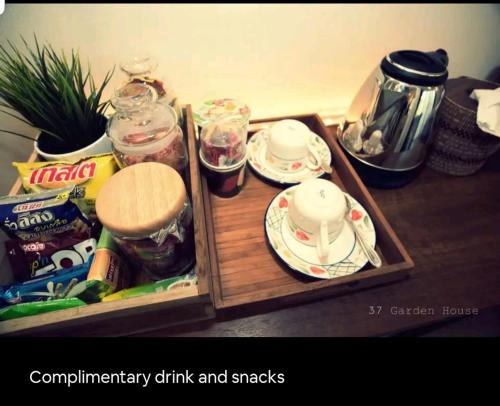 a wooden tray with cups and saucers on a table at 37 Nature House in Bangkok