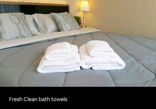 two towels sitting on top of a bed at 37 Nature House in Bangkok