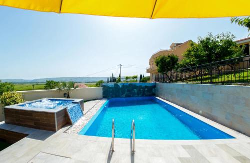 a swimming pool on the roof of a house at Luxury Villa with Private Pool and Jacuzzi in Gnojnice