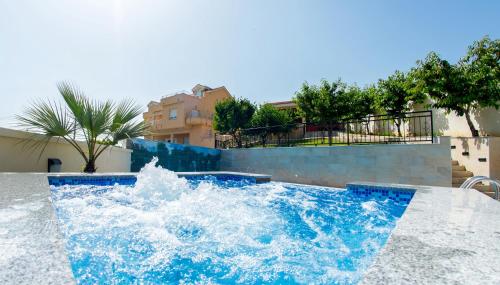 a water fountain in the middle of a pool at Luxury Villa with Private Pool and Jacuzzi in Mostar