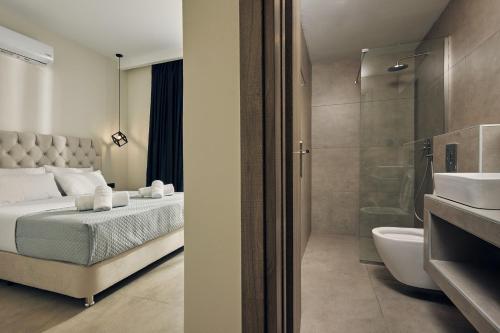a bedroom with a bed and a bathroom with a shower at Mouzaki's Stone Villas in Volímai