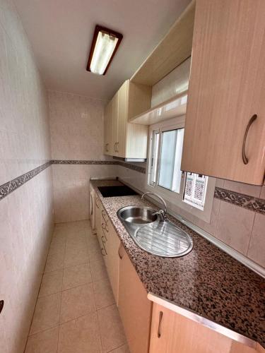 A kitchen or kitchenette at La Vela Playa 2