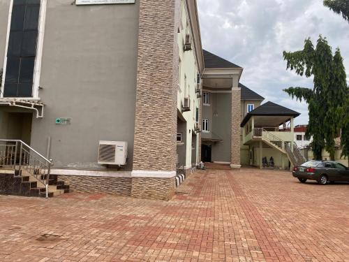 a brick driveway in front of a building at Nue-Crest Hotels & Suites in Enugu
