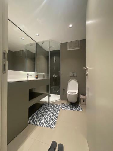 y baño con aseo, lavabo y ducha. en Milpark suites, en Estambul