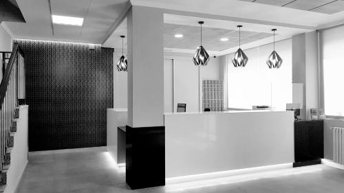 a lobby with a white counter in a room at Hotel Castilla in Albacete