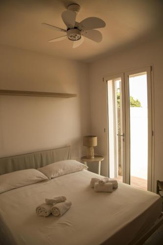 a bedroom with a bed with two towels on it at Le Casette del Bosco in Favignana