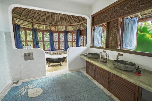 a bathroom with a tub and a sink and a bath room at Boutique Hotel Matlai in Michamvi
