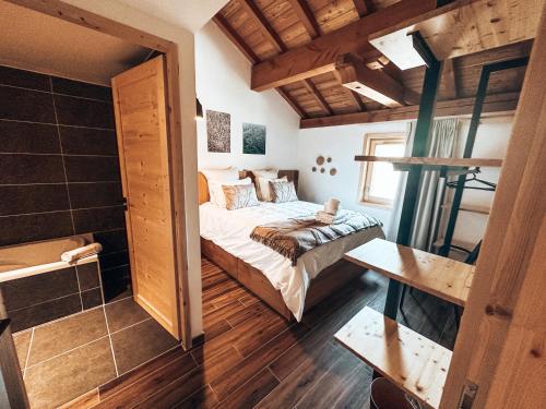 - une petite chambre avec un lit et une salle de bains dans l'établissement L'Aqui Sana, Appartement de standing, au Monêtier-les-Bains