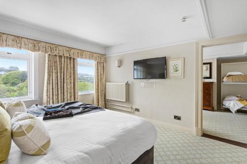 a hotel room with a large bed and a window at Thurlestone Hotel in Thurlestone