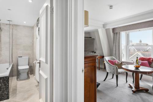 a bathroom with a toilet and a table in a room at Thurlestone Hotel in Thurlestone
