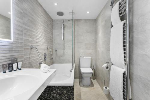 a bathroom with a sink and a toilet and a shower at Thurlestone Hotel in Thurlestone