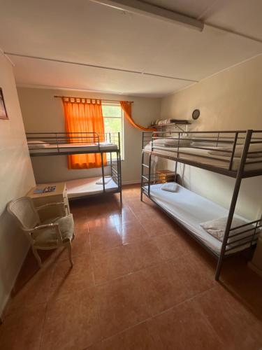 a room with two bunk beds and a window at Emile Youth Hostel in Gibraltar
