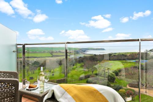 a balcony with a view of a golf course at Thurlestone Hotel in Thurlestone