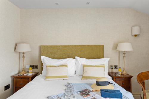 a hotel room with a bed with a hat on it at Thurlestone Hotel in Thurlestone