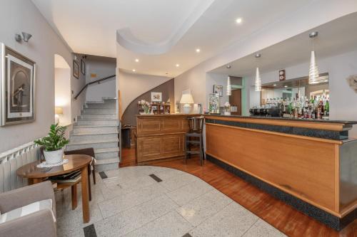 a bar with a counter and a staircase in a room at Hotel Nostromo in Rabac