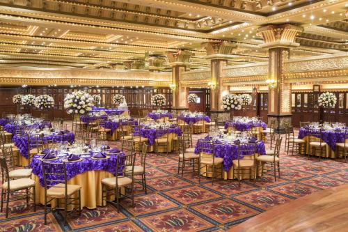 a banquet hall with purple tables and chairs at Mercure Alameda Quito in Quito