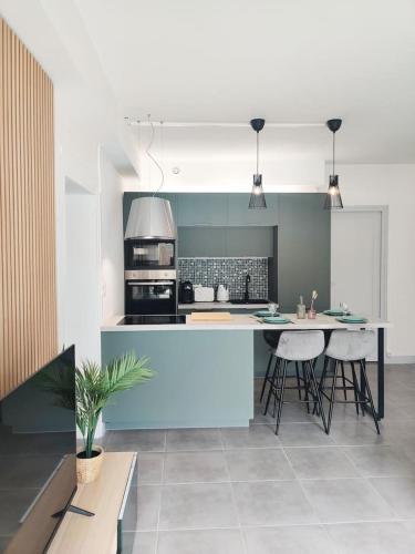 - une cuisine avec un îlot bleu dans l'établissement Da Vinci - Charmant et Relax, à Amboise