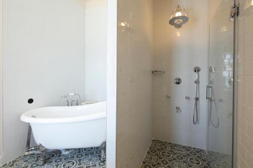 a bathroom with a tub and a sink and a shower at Rasim Palas - Adults Only in Cesme