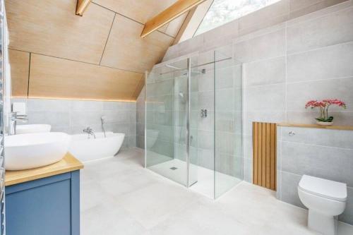a bathroom with a sink and a toilet and a shower at Luxury 8 bedroom home with leisure wing in Boars Hill