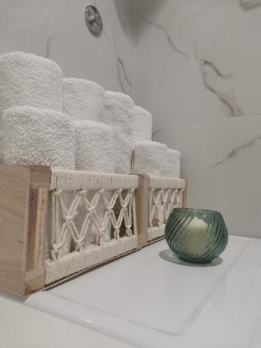 a vase sitting next to a wooden box with towels at Beach Pearl in Bečići