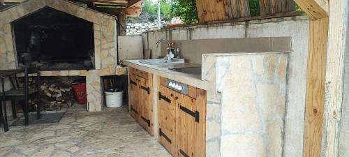 a kitchen with a sink and a counter top at Kuća za odmor Postonjski in Maslenica