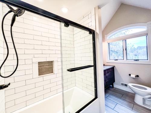 a bathroom with a shower and a toilet at Lakefront Home Near Wisp with Great Location Dock Slip Hot Tub in McHenry
