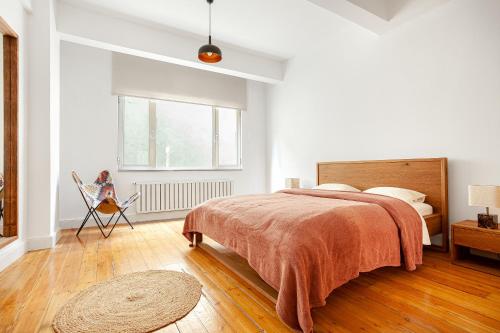 a white bedroom with a bed and a window at NOA - Serdar-ı Ekrem 31 in Istanbul