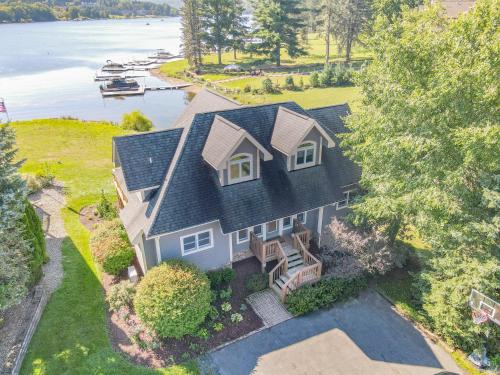 an aerial view of a house with a lake at Lakefront Home Near Wisp with Great Location Dock Slip Hot Tub in McHenry