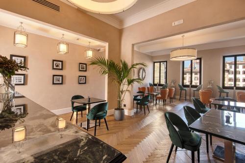 a restaurant with tables and chairs in a room at Relais Uffizi in Florence