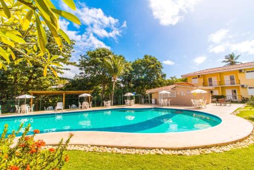 a swimming pool in the yard of a house at Apart Hotel Boulevard da Praia - Portal Hotéis in Porto Seguro