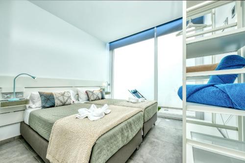 1 dormitorio con 2 camas y balcón en Karma Famara 2 25m del mar en Famara