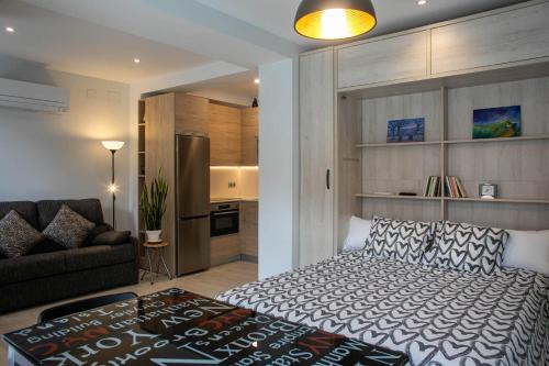 a bedroom with a bed and a couch in a room at ARABA9 in Zarautz