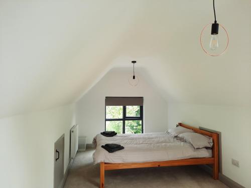 a bedroom with a bed and a window at Corradiller Quay, Lisnaskea, Fermanagh in Lisnaskea