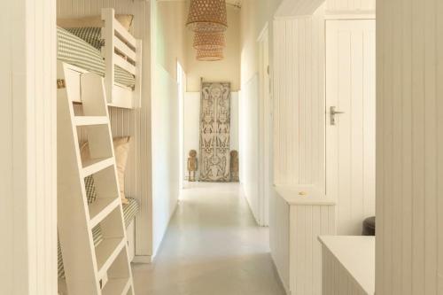 a hallway of a home with white walls and white floors at Tranquility in Cape St Francis