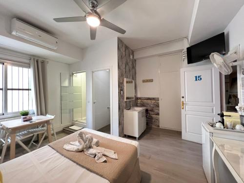 a room with a bed and a kitchen with a table at VALENCIA SUITS YOU Centro Histórico, Establecimiento Automatizado-Fast Auto Check in&Out, Solo para Adultos-Adults only in Valencia