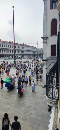 a large group of people walking around a building at Bellevue Luxury Rooms - San Marco Luxury in Venice