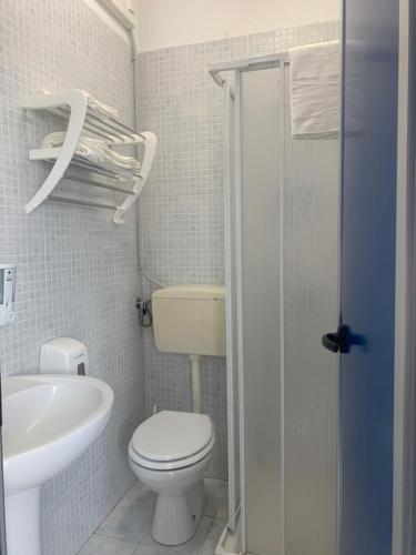 a small bathroom with a toilet and a sink at ORION AFFITTACAMERE in Molfetta