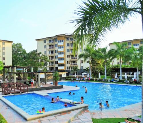 a group of people swimming in a swimming pool at Jaco Costa Linda Condo in Jacó