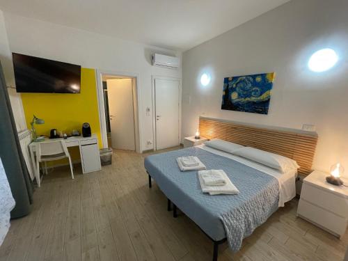 Dormitorio con cama, escritorio y TV en My Bnb Pisa, en Pisa
