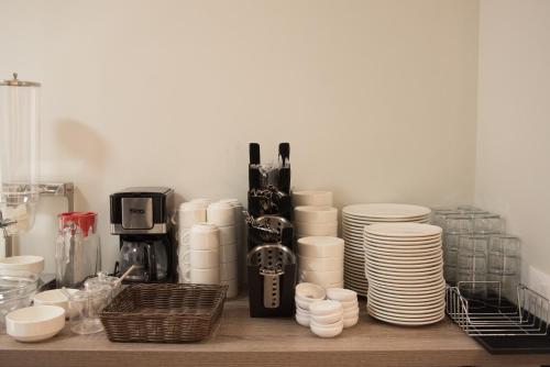 a counter with a bunch of plates and cups at Comfort Rooms Pogradec in Pogradec