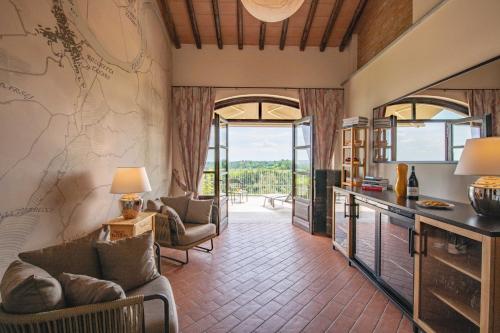 a living room with a couch and a table at Braida Wine Resort in Rocchetta Tanaro